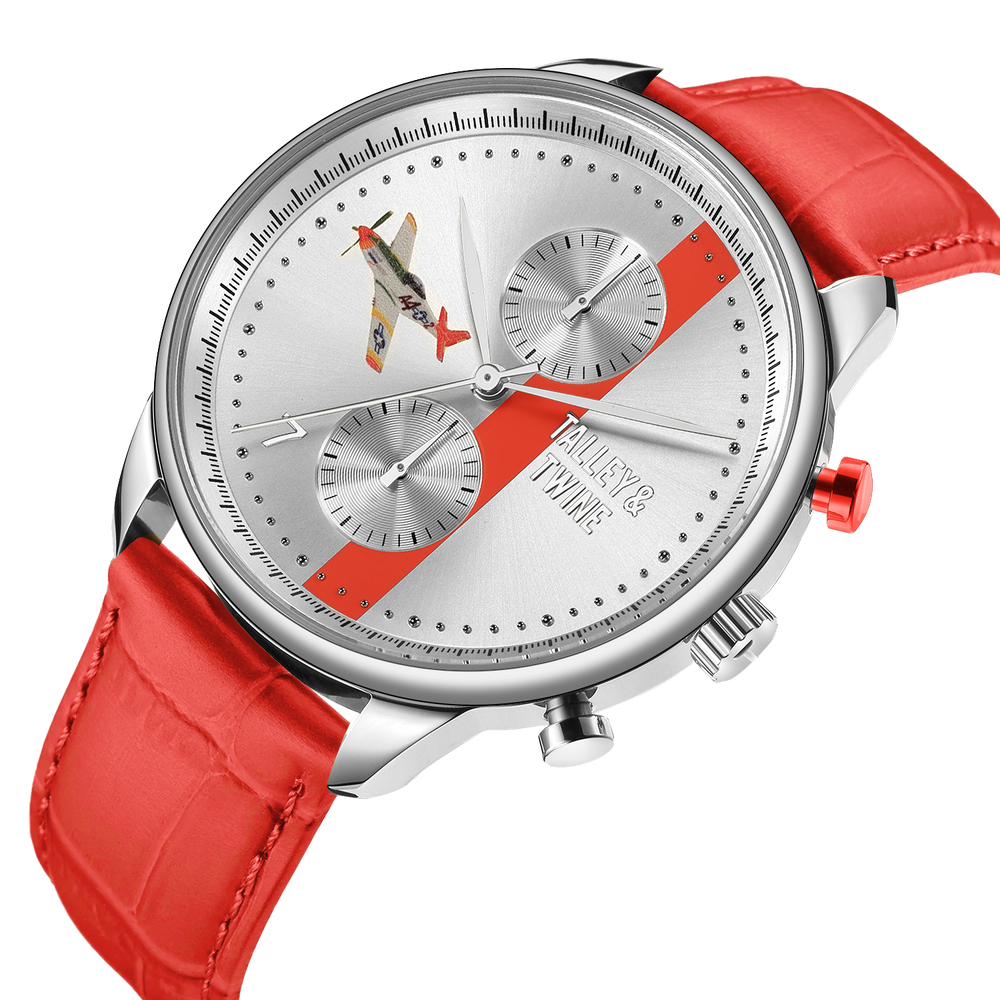 Tuskegee Airmen "Red Tails" watch with a silver dial, red leather strap, and airplane design on the face.